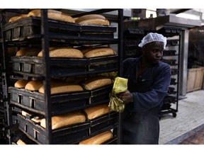 KAMPALA, UGANDA - JUNE 14: A baker makes bread, made from wheat flour, at a bakery on June 14, 2022 in Kampala, Uganda. This factory, one of the largest in the country, bakes around 300,000 loafs of bread a month and has had to raise prices in response to the wheat price increasing. The company also produces flour, which it currently sells at UGX168,000/50kg, up from UGX138,000 two weeks ago, and expects to raise prices again in a few weeks to UGX190,000. Around half of Uganda's wheat imports come from Russia and Ukraine, where production and export have been diminished by the ongoing war.