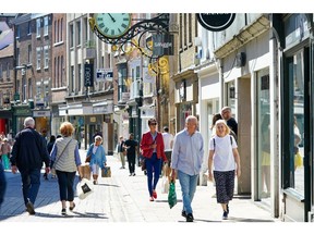 Shoppers walk along a retail street in the city centre of York, UK, on Monday, June 20, 2022. On Wednesday, inflation is set to rocket to a new 40-year high with the cost of goods leaving factories already racing ahead at a double-digit pace. Photographer: Ian Forsyth/Bloomberg