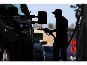 A customer holds a fuel nozzle at a Shell gas station in Hercules, California, U.S., on Wednesday, June 22, 2022. President Joe Biden called on Congress to suspend the federal gasoline tax, a largely symbolic move by an embattled president running out of options to ease pump prices weighing on his party's political prospects.