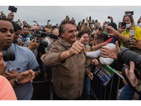 Jair Bolsonaro, Brazil's president, center, greets attendees at a rally during Bahia's Independence Day in Salvador, Bahia state, Brazil, on Saturday, July 2, 2022. Former leftist president Luiz Inacio Lula da Silva still leads the Brazilian presidential race in a potential runoff against incumbent Bolsonaro, a survey carried out between June 20-24 by Futura for Modalmais shows.