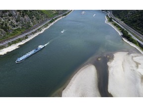 Oil tanker Calcit 12 sails past dry banks on the Rhine River near Oberwesel, Germany, on Thursday, July 14, 2022. A heatwave has sent levels on parts of the river, key for shipping everything from coal to oil, to the lowest in at least 15 years on a seasonal basis.