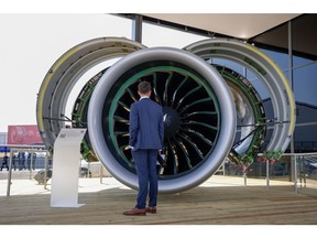 An attendee looks at a model of a Pratt & Whitney engine on the opening day of the Farnborough International Airshow in Farnborough, UK, on July 18.