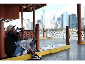 NEW YORK CITY - JULY 21: A man takes a drink of water while riding on the Staten Island Ferry on a sweltering afternoon as temperatures reach into the 90s on July 21, 2022 in New York City. Much of the East Coast is experiencing higher than usual temperatures as a heat wave moves through the area forcing residents into parks, pools and beaches to escape the heat.