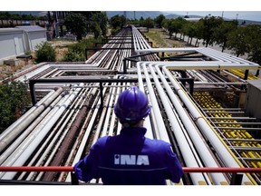 An employee looks out from a platform across pipework at the INA Industrija Nafte d.d. oil refinery in Urinj, Croatia, on Monday, July 18, 2022. The European Union last week gave its final approval for Croatia to join the euro zone early next year as the region looks to strike a delicate balance between bringing down inflation and sustaining output as the region risks a total cut off of Russian gas. Photographer: Oliver Bunic/Bloomberg
