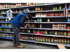 A worker stocks the shelves of a Walmart store in the Uptown Mall in Victoria, British Columbia, Canada, on Tuesday, July 26, 2022. Consumer price inflation accelerated in June to the highest level since January 1983, maintaining pressure on the Bank of Canada to continue delivering aggressive interest rate hikes.