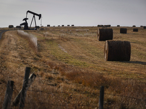 A pumpjack works at a well head on an oil and gas installation near Cremona, Alta.