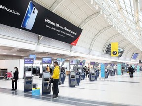 A passenger checks in at Toronto's Pearson International Airport on Friday, Oct. 29, 2021. Pearson International Airport is launching a new digital tool aimed at helping passengers navigate through the current strained air transportation system.