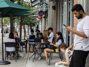 The House of Commons industry committee will hold two hearings today about the Rogers outage that lasted more than 15 hours and left millions of Canadians in a communications blackout. People use Starbucks' provided WIFI at a store in Toronto amid a nationwide Rogers outage, affecting many of the telecommunication company's services, Friday, July 8, 2022.