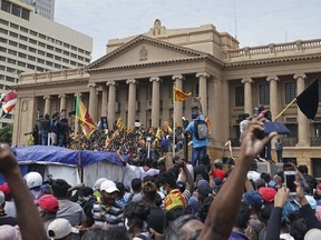 Protesters, many carrying Sri Lankan flags, gather outside the presidents office in Colombo, Sri Lanka, Saturday, July 9, 2022. Sri Lankan protesters stormed President Gotabaya Rajapaksa's residence and nearby office on Saturday as tens of thousands of people took to the streets of the capital Colombo in the biggest demonstration yet to vent their fury against a leader they hold responsible for the island nation's worst economic crisis.