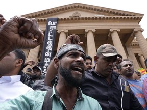 Protesters shout anti government slogans outside president's office as the Parliament votes to elect the new president in Colombo, Sri Lanka, Wednesday, July 20, 2022.