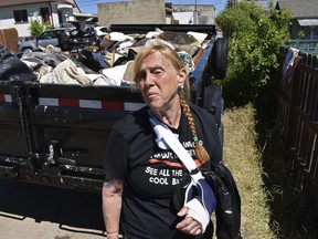 Pam Smith is seen in front of a trailer filled with her belongings that were ruined in flooding, in Red Lodge, Mont., on June 16, 2022. Smith said she received no warning before a creek inundated her neighborhood last month during flash flooding across the region that includes Yellowstone National Park.