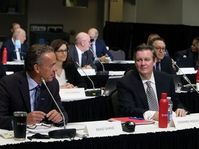Edward Rogers, right, Chairman of Rogers Communications Inc. and Brad Shaw, Chairman and CEO of Shaw Communications Inc., chat before the start of the CRTC hearing looking into the merge of the two communication companies in Gatineau, Que., on November 22, 2021.