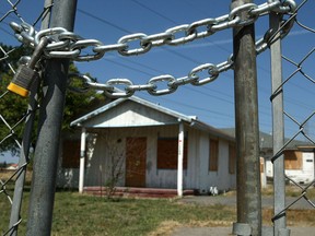 A home stands behind a padlocked gate in Stockton California during the U.S. housing crisis. This downturn will not be as bad, argues Capital Economics.