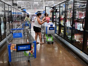 People shop for frozen food at a Walmart in California.