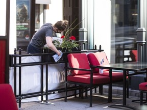 A staff member prepares the patio for Friday's reopening at a downtown Ottawa pub, as Ontario prepares to enter the first phase of its reopening plan amidst the third wave of the COVID-19 pandemic, on June 10, 2021.