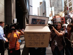 An employee of Lehman Brothers Holdings Inc. carries a box out of the company's headquarters in New York in 2008, after the company filed for bankruptcy. Photographer: Chris Hondros/Getty Images