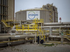 FILE - Operators work at the Enagss regasification plant, the largest LNG plant in Europe, in Barcelona, Spain, Tuesday, March 29, 2022. The European Union's plan to reduce the bloc's gas use by 15% to prepare for a potential cutoff by Russia this winter has been met with sharp skepticism by Spain and Portugal, two governments that are usually big supporters of the bloc. Madrid and Lisbon on Thursday, July 21, 2022 said they would not support the initiative announced by European Commission Ursula von der Leyen on Wednesday.