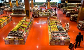 People shop in the produce section at Loblaws at Maple Leaf Gardens in Toronto.