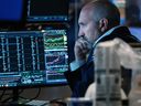 Traders work on the floor of the New York Stock Exchange.