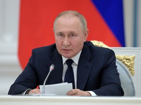 Russian President Vladimir Putin attends a meeting with parliamentary leaders in Moscow, Russia.