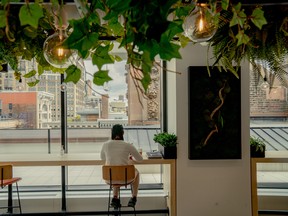An employee sits at a cafe in the Mastercard office in the Flatiron District of New York, U.S.