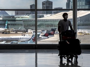 A traveller walks with his luggage at Toronto Pearson International Airport’s Terminal 1.