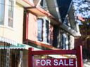 A for sale sign is displayed in front of a house in the Riverdale area of ​​Toronto.