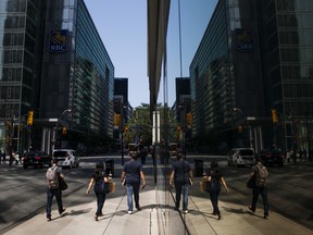Pedestrians walk in Toronto's financial district.