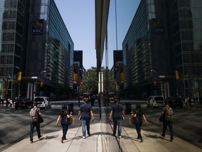 Pedestrians walking in the financial district of Toronto.