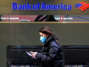 A person walks past a Bank of America sign in the Manhattan borough of New York City.