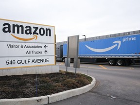 FILE - An Amazon Prime truck passes by a sign outside an Amazon fulfillment center on Staten Island, New York, on March 19, 2020. Amazon is heading into its annual Prime Day sales event on Tuesday, July 12, 2022, much differently than how it entered the pandemic. Once the darling of the pandemic economy, the company posted a rare quarterly loss in April as well as its slowest rate of revenue growth in nearly two decades at 7%.