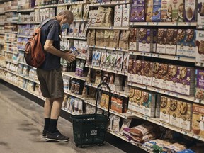 A man shops at a supermarket on Wednesday, July 27, 2022, in New York. The Federal Reserve on Wednesday raised its benchmark interest rate by a hefty three-quarters of a point for a second straight time in its most aggressive drive in three decades to tame high inflation. The Fed is tightening credit even while the economy has begun to slow, thereby heightening the risk that its rate hikes will cause a recession later this year or next.
