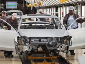FILE - In this Aug. 31, 2017, file photo, workers produce vehicles at Volkswagen's U.S. plant in Chattanooga, Tenn. Volkswagen began production of its first electric vehicle assembled in the United States at a Tennessee plant Tuesday, July 26, 2022. In a news release, the German automaker said it plans to ramp up production in Chattanooga of the ID.4 electric compact SUV to 7,000 cars per month in the fourth quarter of this year, with a goal of increasing that rate next year.