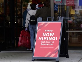 FILE - Hiring sign is displayed outside of a retail store in Vernon Hills, Ill., Saturday, Nov. 13, 2021. U.S. employers advertised fewer jobs in May 2022 as the economy has shown signs of weakening, though the overall demand for workers remained strong. Employers advertised 11.3 million jobs at the end of May, the Labor Department said Wednesday, July 6, 2022, down from nearly 11.7 million in March, the highest level on records that date back more than 20 years.