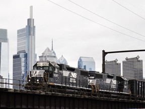 FILE - A Norfolk Southern freight train moves along elevated tracks in Philadelphia, Wednesday, Oct. 27, 2021. Railroads will be required to maintain two-person crews under a new rule announced Wednesday, July 27, 2022, that will thwart the industry's efforts to cut crews down to one person.