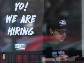 A hiring sign is displayed at a restaurant in Schaumburg, Ill., Friday, April 1, 2022. More Americans applied for unemployment benefits last week, and while layoffs remain low, it's the fifth straight week claims have topped the 230,000 mark. Applications for jobless aid for the week ending July 2 rose to 235,000, up 4,000 from the previous week, the Labor Department reported Thursday, July 7.