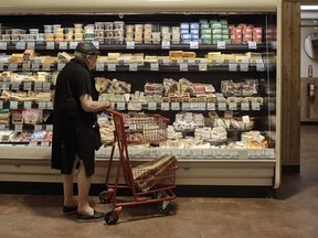 A man shops at a supermarket on Wednesday, July 27, 2022, in New York. An inflation gauge that is closely tracked by the Federal Reserve, Friday, July 29, jumped 6.8% in June from a year ago, the biggest increase in four decades, and leaving Americans with no relief from surging costs.