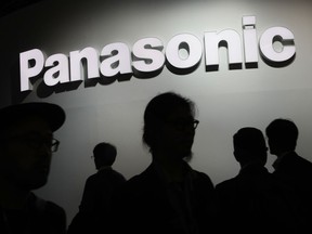 FILE - People walk by the Panasonic booth during CES International, on Jan. 9, 2018, in Las Vegas. Japan's Panasonic Corp. selected Kansas as the location for a multibillion-dollar mega-factory to produce electric vehicle batteries for Tesla and other carmakers, Gov. Laura Kelly announced Wednesday, July 13, 2022.
