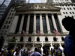 FILE - Pedestrians walk past the New York Stock Exchange on Friday, July 8, 2022, in New York. Stocks are falling on Wall Street on Wednesday, July 13, 2022, after a highly anticipated report on inflation turned out to be even worse than expected.