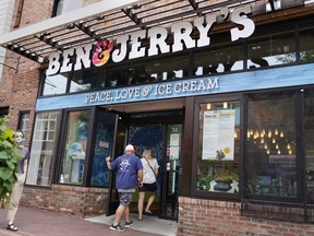 FILE - Two patrons enter the Ben & Jerry's Ice Cream shop, July 20, 2021, in Burlington, Vt. The Vermont-based ice cream maker is suing its corporate parent Unilever over a plan that would allow its product to be sold in east Jerusalem and the occupied West Bank. In a lawsuit filed Tuesday, July 6, 2022 in New York, the ice cream maker asked a court to block the decision by Unilever to sell the business interest in the ice cream company in Israel to a local company that would sell ice cream with Hebrew and Arabic labeling poses "poses a risk" to the integrity of the Ben & Jerry's brand name.