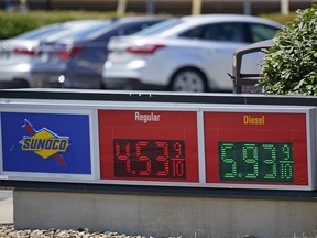 FILE - Gas prices are displayed at a Sunoco gas station along the Ohio Turnpike near Youngstown, Ohio, Tuesday, July 12, 2022. US consumer confidence slid again in July 2022, as concerns about higher prices for food, gas and just about everything else continued to weigh on Americans. The Conference Board said Tuesday, July 26, 2022, that its consumer confidence index fell to 95.7 in July from 98.4 in June, largely due to consumers' anxiety over the current conditions, particularly four-decade high inflation.