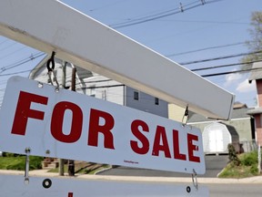 FILE - A "for sale" sign hangs from a post outside of a vacant business building in Belleville, N.J., Thursday, May 3, 2018. The Federal Reserve on Wednesday, July 27, raised its benchmark interest rate by a hefty three-quarters of a point for a second straight time in its most aggressive drive in three decades to tame high inflation. By raising borrowing rates, the Fed makes it costlier to take out a mortgage or an auto or business loan.