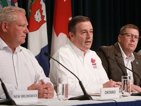 Alberta Premier Jason Kenney, centre, with Ontario Premier Doug Ford, left, and Saskatchewan Premier Scott Moe at the meeting of provincial and territorial premiers in 2019. Kenney is calling on Canada’s premiers meeting this week in Victoria to move to mutual recognition of provincial regulations.