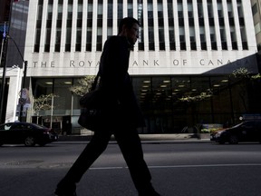 A pedestrian passes in front of a Royal Bank of Canada building in Toronto. RBC economists forecast Canada will enter a recession in 2023.