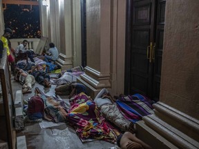 Protesters sleep before being removed from the site of a protest camp inside the Presidential Secretariat in Colombo, Sri Lanka, Friday, July 22, 2022.