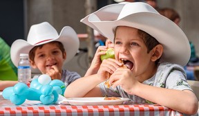 Luke, a six-year-old Luke from Houston, Texas, chows down on his Stampede breakfast on Thursday.
