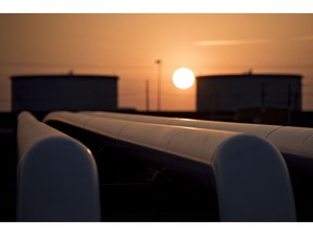 The sun rises beyond oil storage tanks at the Enbridge Inc. Cushing storage terminal in Cushing, Oklahoma. Crude stockpiles in the U.S. probably rose by 4.2 million barrels in the week ended March 27, according to the median forecast in the Bloomberg survey of eight analysts before the Energy Information Administration's report.