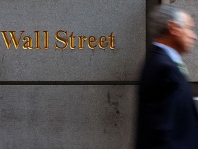 A man walks along Wall Street in New York.