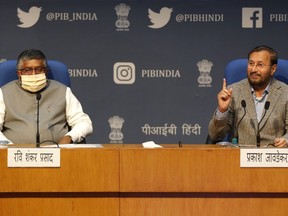 FILE - India's Information Technology Minister Ravi Shankar Prasad, left, and Information and Broadcasting Minister Prakash Javadekar address a press conference announcing new regulations for social media companies and digital streaming websites in New Delhi, India, Feb. 25, 2021. Twitter on Tuesday, July 5, 2022, challenged the Indian government in court over its recent orders to take down some content on the social media platform. The lawsuit is part of a growing confrontation between Twitter and New Delhi after the government passed the new set of sweeping regulations giving it more power to police online content.