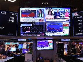 Financial News is seen on a television as traders work on the floor of the New York Stock Exchange on Aug. 29. Stocks continued their downward trend of last week in reaction to Federal Reserve Chair Jerome Powell's remarks on inflation at the central bank's annual Jackson Hole economic symposium.